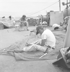 Stan Poole repairing nets.