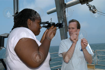 Ken Houtler teaching DeAnna McCadney how to use a sextant to navigate.