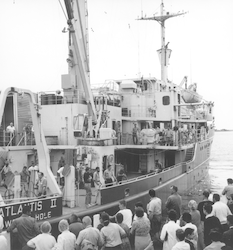 Atlantis II departing, crowd gathered on dock