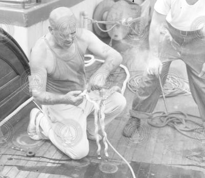 Arvid Karlson splicing rope on Atlantis deck.
