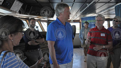 Rick Armstrong, son of Neil Armstrong, talking to people on the ship's bridge.