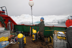 Will Ostrom deploying moored sensors in Sermilik Fjord, Greenland.