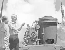 Al Woodcock and a colleague run a smoke generator.
