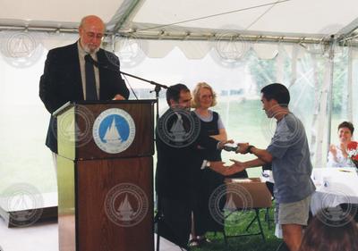 John Farrington (at podium), Bob Gagosian, Judy McDowell and graduate Derek Fong.