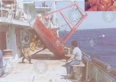 William Ostrom and Mel Briscoe on deck with large buoy