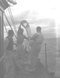 Dean Bumpus on deck holding a plankton net