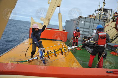 Meghan Donohue (left) deploying ADCP from R/V Nathaniel B. Palmer.