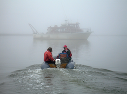 Captain Bill Kopplin and Phil Alatalo in small boat.