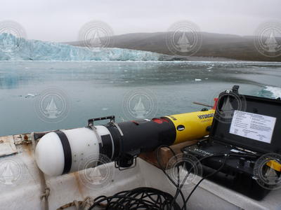 REMUS and control box in the small boat by the glacier.