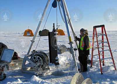Kris Newhall standing with an ITP loaded up for deployment into the ice hole.