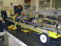 Thermal glider in pieces on a lab bench with John Lund in background.