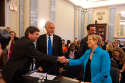 Subcommittee chair Mark Begich greeting Susan Avery.