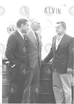 Al Vine on right, talking with unidentified men next to Alvin
