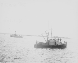 Full view of Mytilus on right, Coast Guard cutter on left
