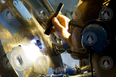 Jefferson Grau preparing holes in sphere for electrical penetrator installation.