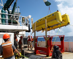 HROV Nereus suspended over the deck of R/V Cape Hatteras.