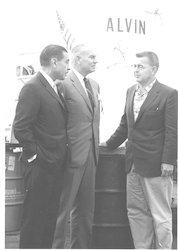 Al Vine on right, talking with unidentified men next to Alvin