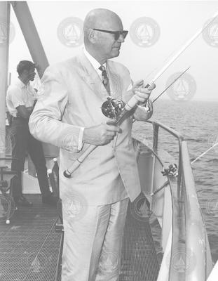 President  of Finland, Urho Kekkonen, with fishing pole, onboard Knorr.