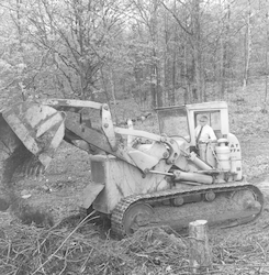 Paul M. Fye driving bulldozer to clear ground for Clark Lab.