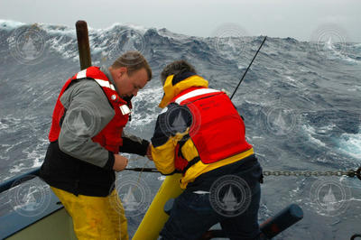John Lund and Bob Weller deploy an Apex float during rough weather.