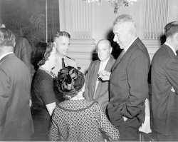Columbus Iselin (right) talking with group.