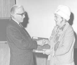 Ruth Carlson shaking hands with Paul Fye