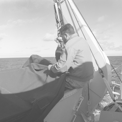 Michael Palmieri sewing a boat cover on the Atlantis II.