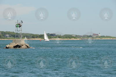 A sailboat passing through Great Harbor in front of Nobska Point.