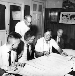 Arthur Miller (2nd from right) explaining graphs to guests
