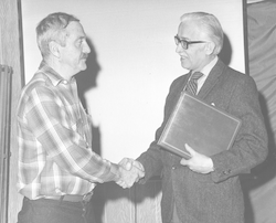 Stanley Poole shaking hands with Paul Fye