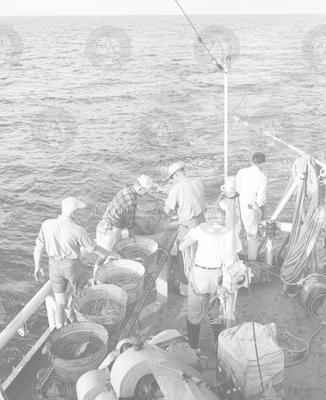 Group aboard Crawford working with lines and buckets