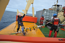 Meghan Donohue (left) deploying ADCP from R/V Nathaniel B. Palmer.