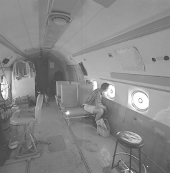 Inside view of C54Q aircraft, man looking out window