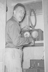 Joe McElliott with direction finder aboard Albatross III