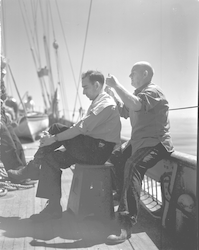 Otto Solberg giving Capt Adrian Lane a haircut on deck.