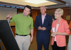 John Collins briefing Sen. Warren and Rep. Keating on his research.