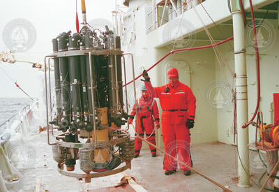 Shelley Ugstad and Marshall Swartz (front) deploying a CTD water sampling rosette.