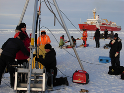 Researchers deploying sub-ice ITP mooring in the Arctic.