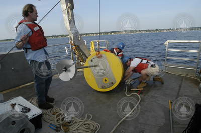 Ken Houtler assisting as Dave Ralston and Jay Sisson work with a mooring.