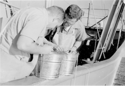 Nat Corwin and Francis Richards on deck looking at samples