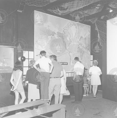 Visitors looking at displays at the Hangar Exhibit Center.