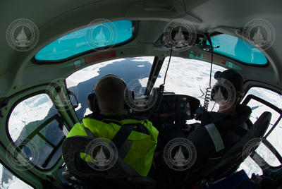 View forward from back seat of helicopter.