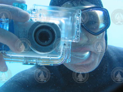 Mark Spear snapping photos of Alvin crew from outside through a view port.