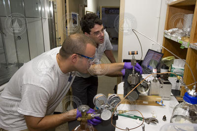 Sean Sylva and Jeff Seewald monitor gas and oil separation during sample extraction.