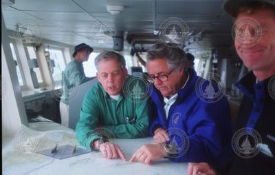 Dudley Foster and Charley Hollister looking over charts.