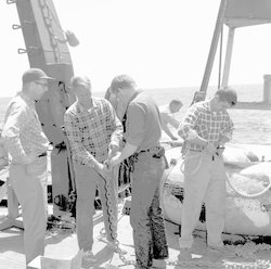 John Beckerle (left) and Warren Witzell with group working on deck during Chain cruise