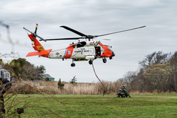 USCG Jayhawk helicopter ascending to lift LRAUV Polaris off its cradle.