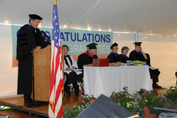 Jim Yoder speaking from podium during Commencement.