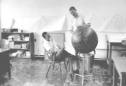 William Metcalf and Rocky Miller looking at globe