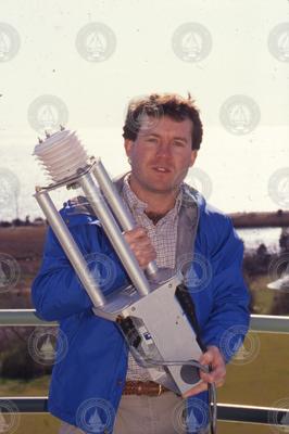 Jim Edson holding an air-sea sensor.